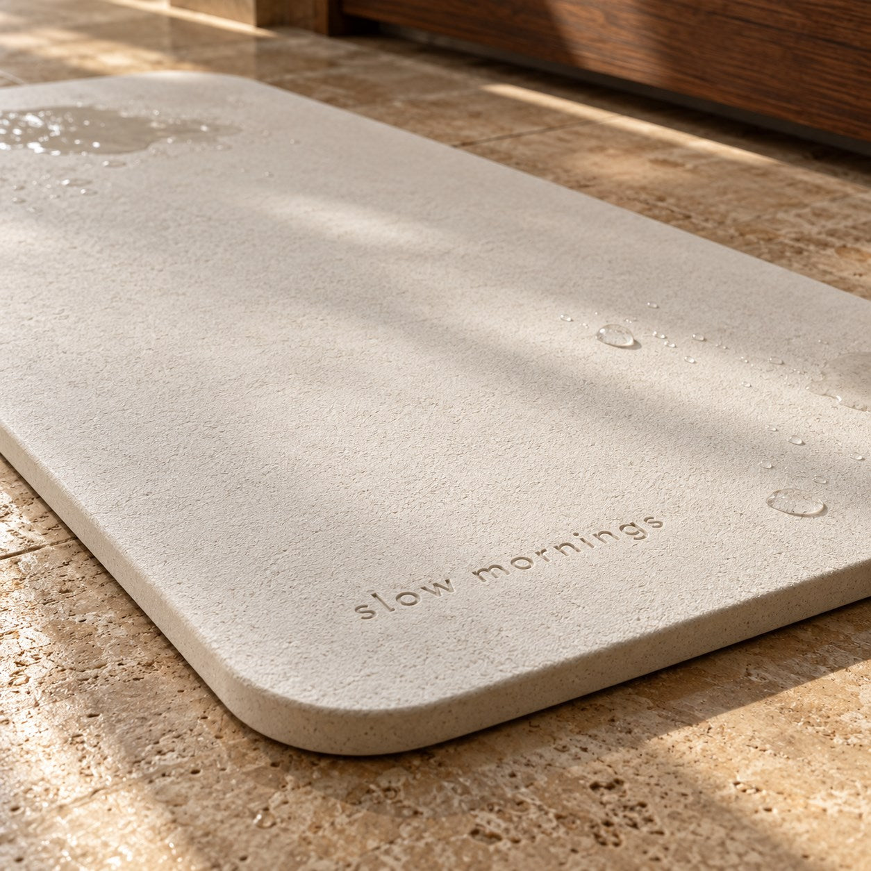 Illustrated mineral surface and engraved words on a bath mat